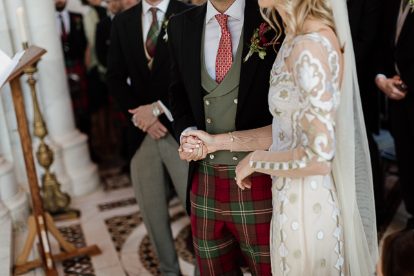 bride and groom holding hands during liturgy