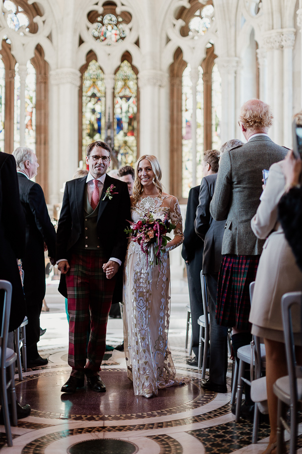 newlyweds walking down the aisle at mount stuart
