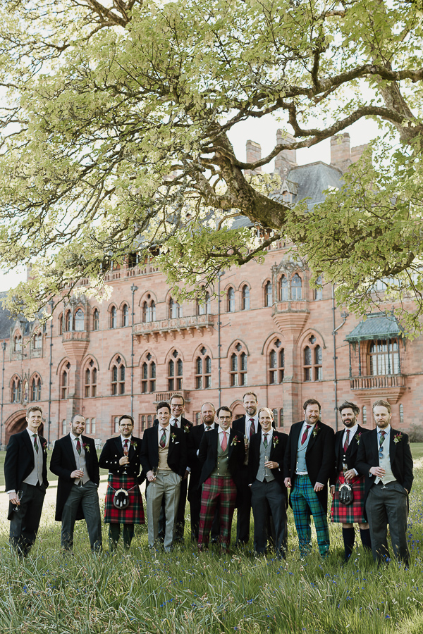 groomsmen posing together in tartan
