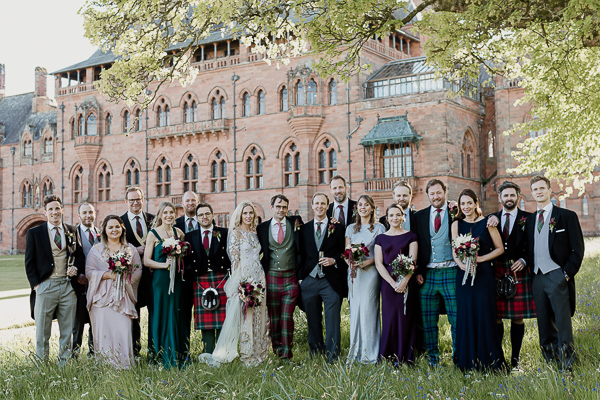 bridal party posing for a picture in scotland