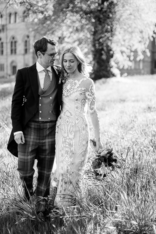 bride and groom walking in teh garden in scotland