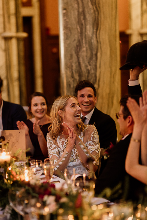 bride and groom laughing at speeches 