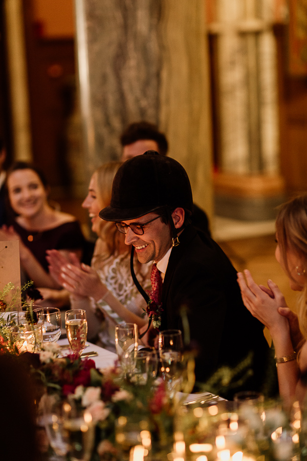 groom is wearing jockey hat at speeches