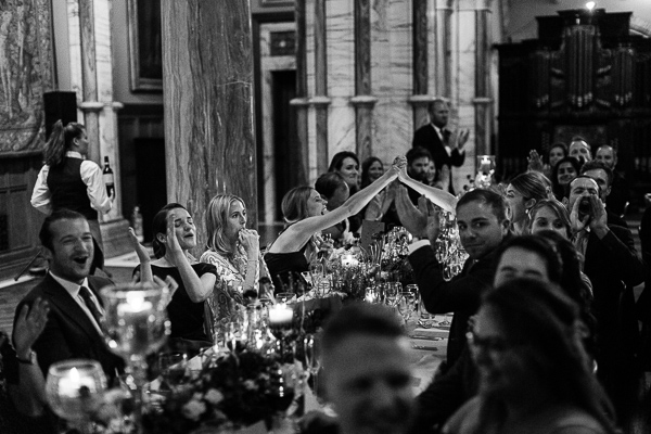 guests cheering during wedding speeches
