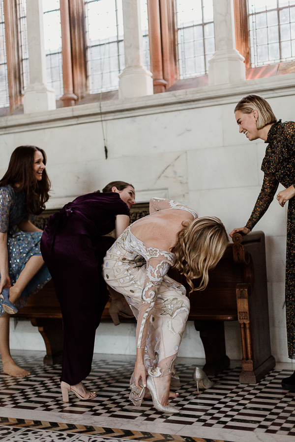 bride with friends taking their shoes off