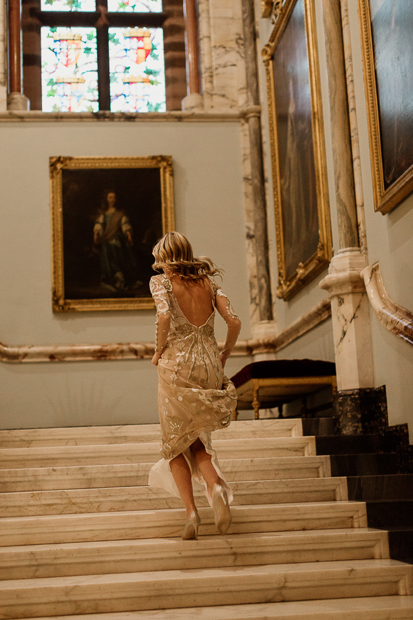 bride running up the stairs to change