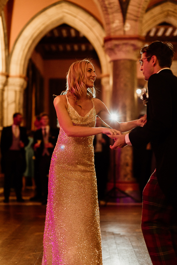bride and groom dancing and smiling to each other