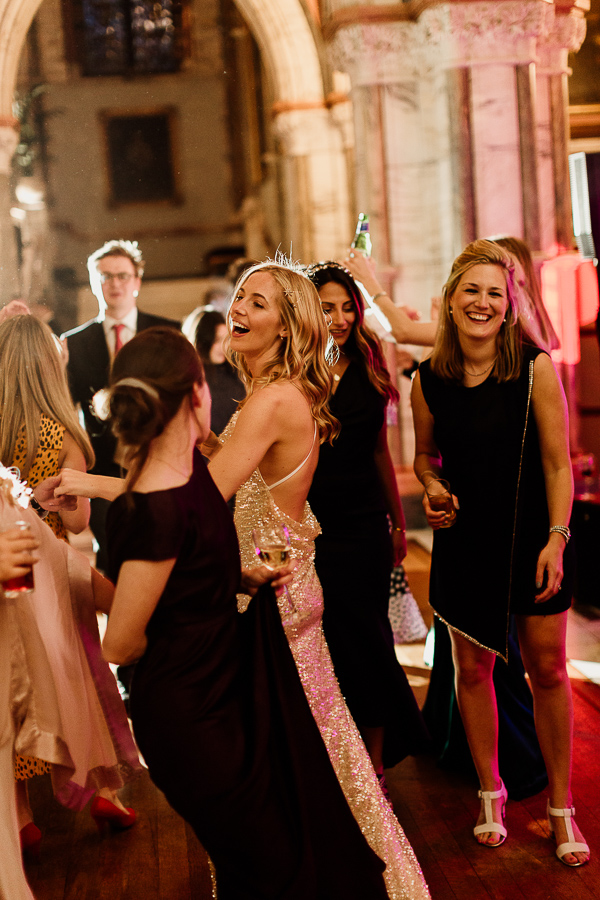 girls smiling and dancing at wedding