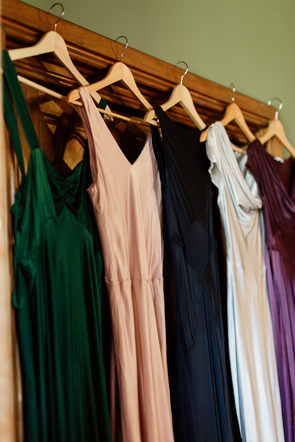 bridesmates dresses multicolour hanging on door