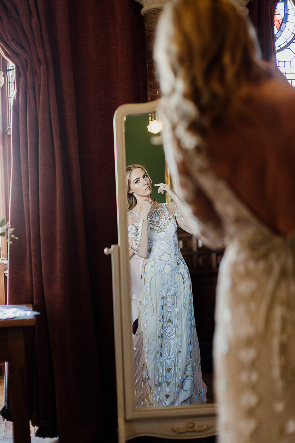 bride getting ready at mount stuart looking in the mirror