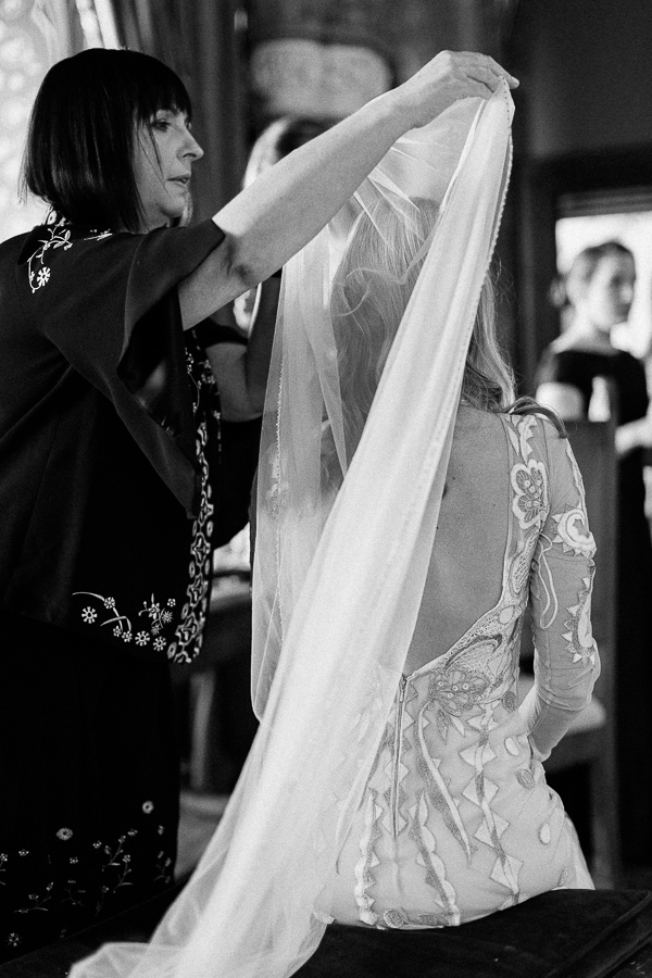 mother of the bride putting veil during preparations 