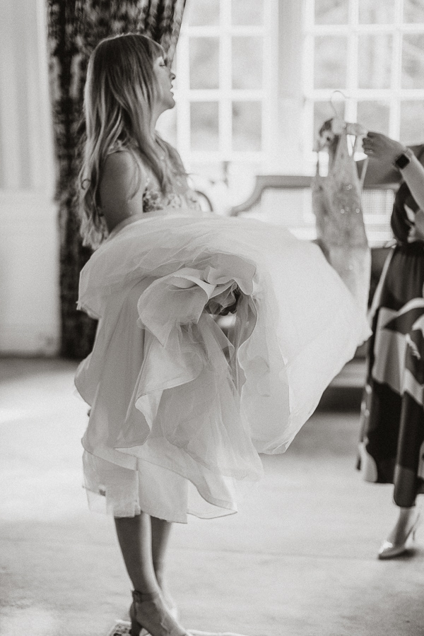bridesmaid holding wedding dress Glenapp wedding venue 