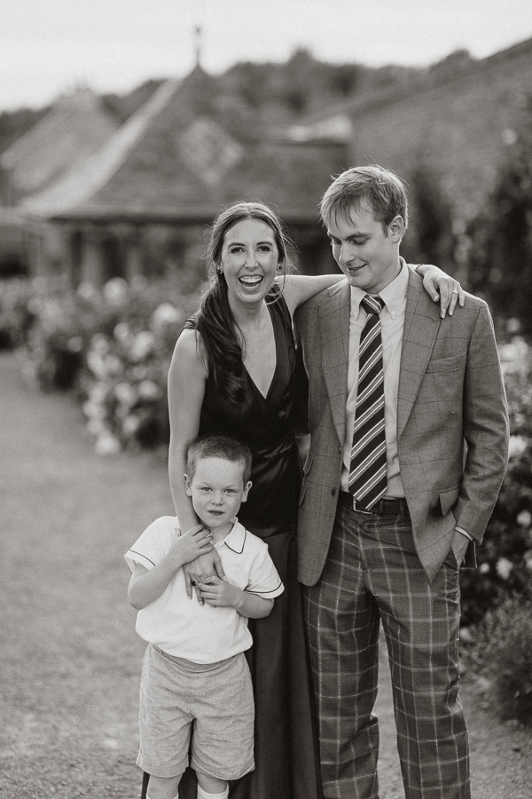 bride and groom to be with page boy in the garden