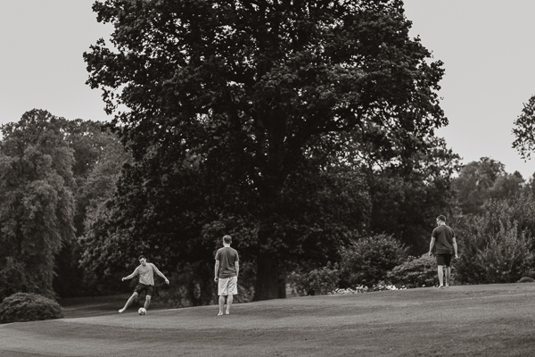 groom playing footbal before wedding soarn castle