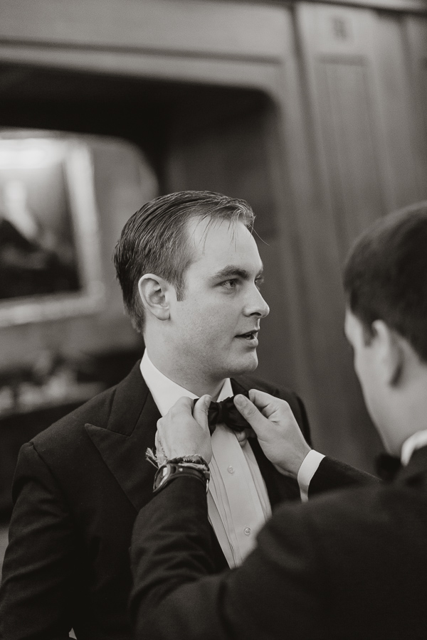 groom getting his bowtie fixed