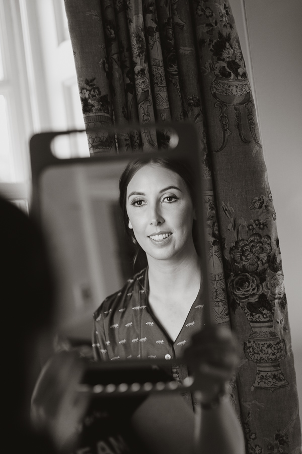 bride looking at herslef in teh mirror