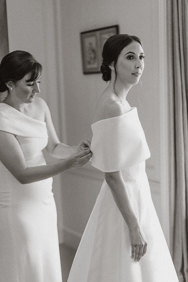 bride having her dress fixed
