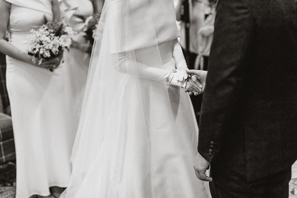bride and groom holding hands during ceremony