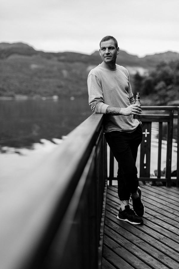 groom in the morning realxing by the shore on loch goil wedding day scotland